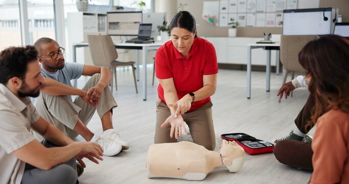 First aid, cpr training and people with mannequin for safety compliance or healthcare. Paramedic course, medical demonstration and teaching emergency rescue technique with hand in business office