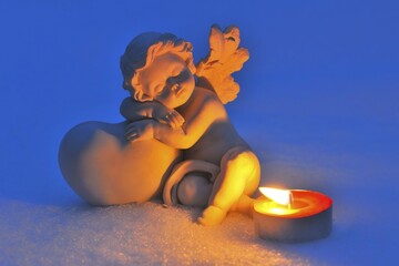 Porcelain figure, angel in the snow, with a tea light