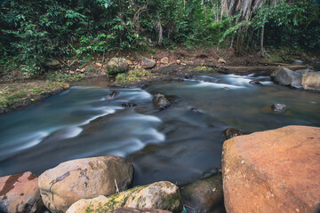 Water Flowing Around Rocks in a Forest River