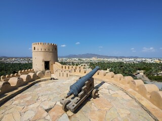 Cannon, Fort Nakhl, or Husn Al Heem, fortress, above oasis Nakhl on Jebel Nakhl solid, historical...