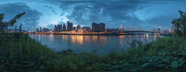 Obraz premium A night view of a modern city, with tall buildings and bright lights. In the center of the picture is a towering skyscraper