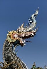 Fototapeta premium Richly decorated Naga at the entrance of Wat Rong Seur Ten, Blue Temple, Chiang Rai, Northern Thailand, Thailand, Asia