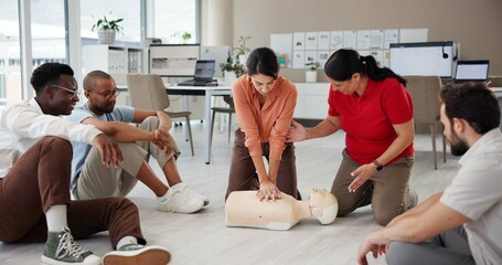 First aid, cpr training and group with dummy for safety compliance, health and chest compression for breathing. Paramedic course, learning and teaching people emergency rescue technique in office