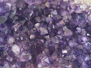 purple crystals of quartz as a background, closeup of photo