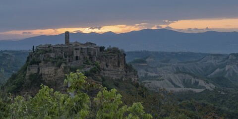 The mountain village of Civita di Bagnoregio in hilly landscape at sunrise, Civita di Bagnoregio, Lazio, Italy, Europe