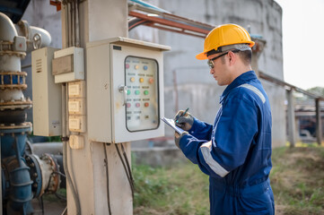 A plumbing engineer is checking the operation of a water supply pump switch.