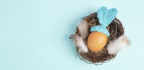 Easter bunny or rabbit in a bird nest, made from an egg and crocheted ears, spring holiday,...