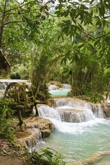 Naklejka premium Kuang Si waterfalls, water wheel and cascades, turquoise colored water, Luang Prabang, Luang Prabang Province, Laos, Asia