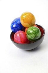 Colorful Easter eggs in a bowl with space for text