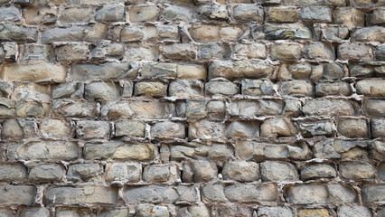 The photo shows a wall made of old bricks close-up