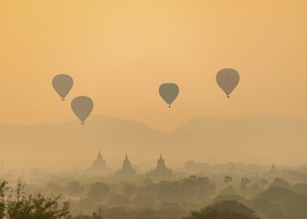View of pagodas with hot air balloons, temples, sunrise, haze, morning light, Bagan, Division...