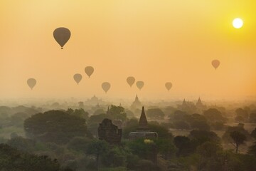 View of pagodas with hot air balloons, temples, sunrise, haze, morning light, Bagan, Division...