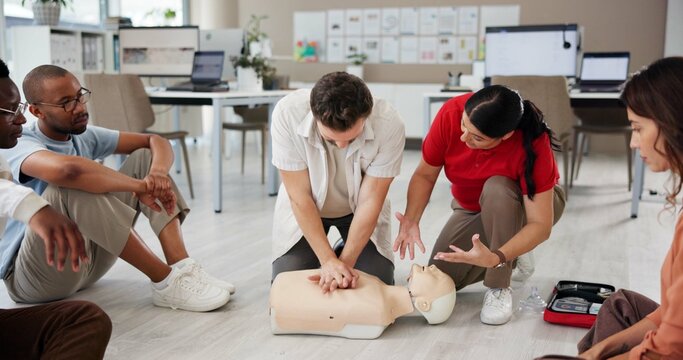 First aid, learning cpr and group with dummy for safety compliance, health and chest compression for breathing. Paramedic course, medical and teaching people emergency rescue technique in office