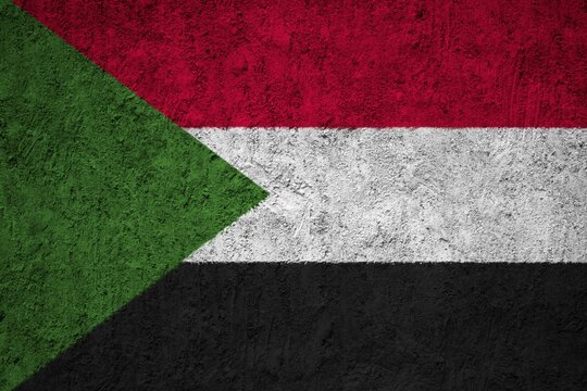 Sudan Flag painted on the cracked grunge concrete wall