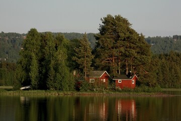 Obraz premium Red houses on a lake island, Sweden, Europe