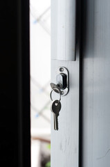 door lock with a key that hangs on the aluminum door
