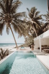 Fototapeta premium Experience tranquility at a stunning beachfront villa featuring an infinity pool, beautifully nestled among swaying palm trees on a bright, sunny day