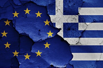 Flags of EU and Greece painted on cracked wall