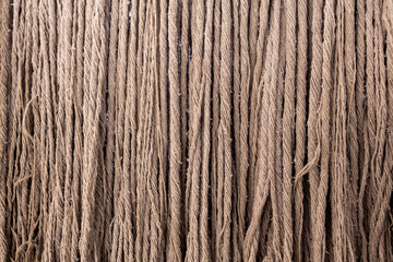 A close-up of a used mop’s yarn, revealing intricate fibers and deep-set stains. The worn texture tells a story of repeated cleaning and use, capturing the essence of everyday household chores.