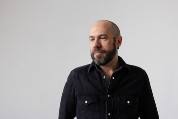 Headshot of smiling mature man looking away posing indoor. Mindset concept.