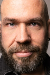 Obraz premium Vertical close-up portrait of bearded mature man posing indoor. Mindset concept.