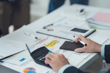 Business Meeting: A confident and focused businesswoman leads a meeting, pointing at a document and engaging in a lively discussion with her team. The image conveys professionalism, collaboration.