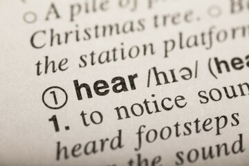 Obraz premium Hear, word in dictionary. macro shot. selective focus