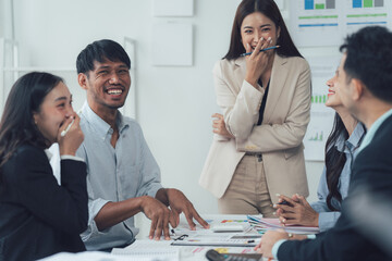 Office Laughter: A group of diverse professionals share a hearty laugh during a workplace meeting, creating an atmosphere of camaraderie, collaboration, and shared joy.
