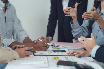Collaborative Brainstorm: A diverse group of professionals actively engage in a collaborative brainstorming session, their hands gesturing excitedly and their expressions focused.