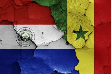 Flags of Paraguay and Senegal painted on cracked wall © daniel0Z/imageBROKER