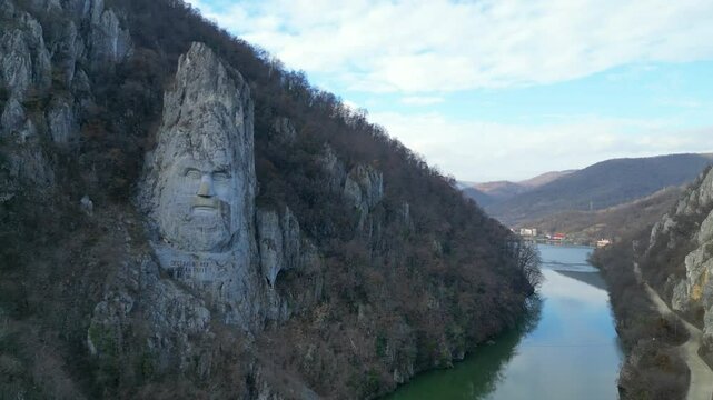 Rock carved statue of the figure of Decebal or Decebalus , on the the kings of historical land of Dacia , first century A.D. ,located in Danube Gorge region, Romania , aerial drone view