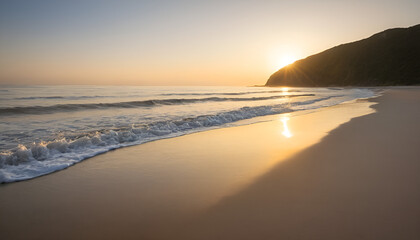 A peaceful sunrise casting golden light on a calm beach