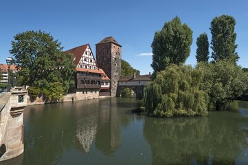 Obraz premium Former leper hospital Weinstadel, half-timbered house, water tower beside Pegnitz, Maxbrücke bridge left, Nuremberg, Middle Franconia, Bavaria, Germany, Europe