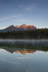 The Bow Range reflected in Herbert Lake at dawn, Banff National Park, Canadian Rockies, Alberta...