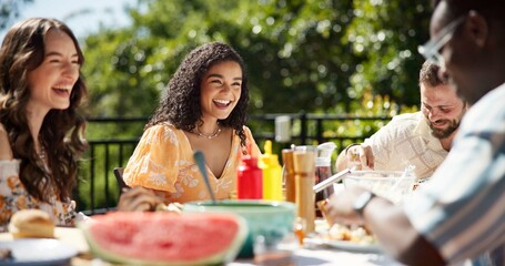 Friends, party and eating lunch outdoor for new year celebration, laughing or bonding together. Terrace, people or happy with food at social gathering for festive reunion, holiday or fun conversation