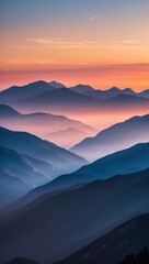 Obraz premium Majestic Sunrise over Mountain Range with Serene Misty Landscape
