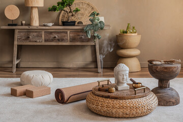 Cozy meditation setup with a woven pouf, yoga mat, and incense burner. A serene Buddha statue and...