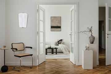 Elegant space with a minimalist cane chair, sculptural decor, and soft tones. A serene blend of modern design and artistic accents.