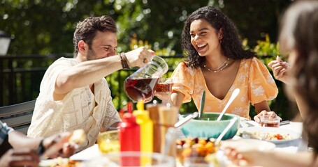 Party, drinks and friends laughing outdoor for new year celebration, funny joke or bonding together. Terrace, people or happy with food for festive lunch, holiday reunion or fun conversation by home