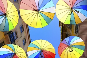 Colorful umbrellas suspended over Pink Street, Lisbon, Portugal, Europe