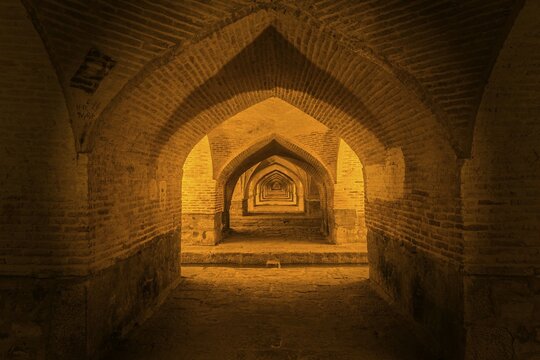 Arches under the illuminated Si-o-se Pol Bridge or Allah-Verdi Khan Bridge, Esfahan, Iran, Asia