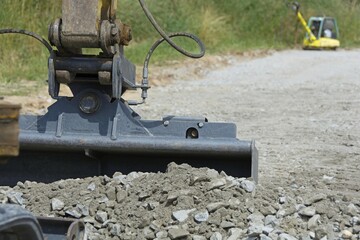 Close-up of excavator shovel with ballast formation