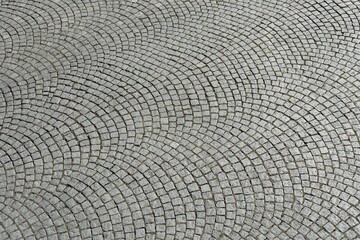 Top view of granite paving in segmental arch bond