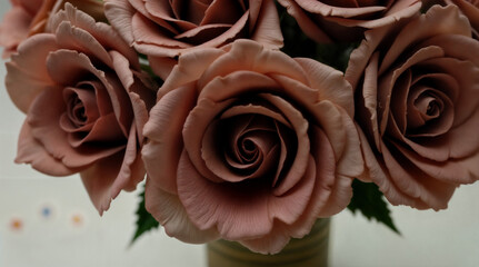 Elegant bouquet of mauve roses.  Close-up view of delicate petals.  Floral artistry.  Beautiful roses in vase.