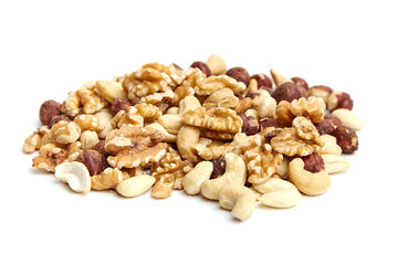 A heap of mixed nuts including walnuts, almonds, cashews, and hazelnuts on a white background. Perfect for healthy snacking or cooking