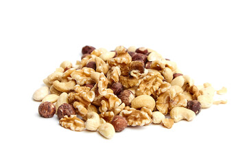 A heap of assorted mixed nuts including walnuts, hazelnuts, cashews, and almonds on a white surface. Perfect for healthy snacks or cooking