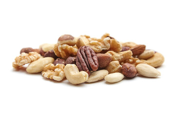 A pile of mixed nuts, including pecans, walnuts, cashews, hazelnuts, almonds, and Brazil nuts, arranged on a white background to emphasize textures and variety