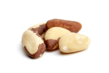 Fototapeta premium A cluster of raw Brazil nuts, featuring smooth ivory surfaces with brown shells, isolated on a white background. Natural textures and details visible