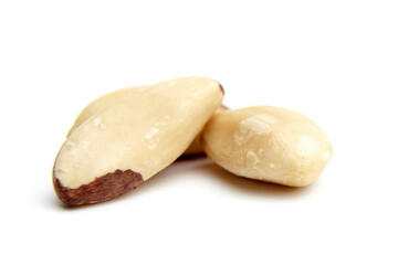 Three Brazil nuts with smooth, creamy surfaces and partial brown skin, isolated on a white background, showcasing natural texture and detail.
