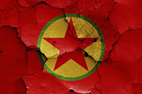 Flag of PKK painted on cracked wall
